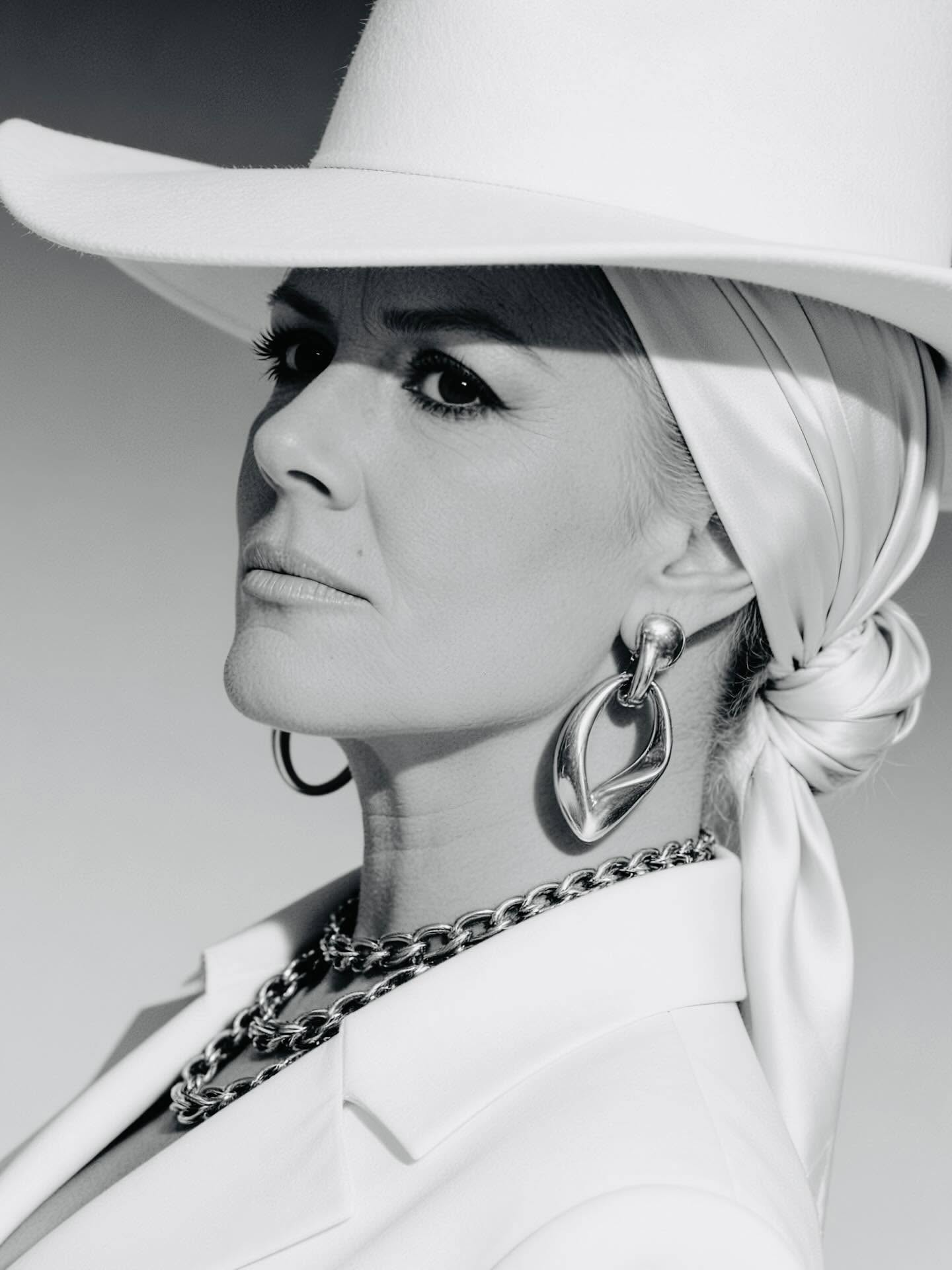 Anita Cochran black-and-white portrait in white hat